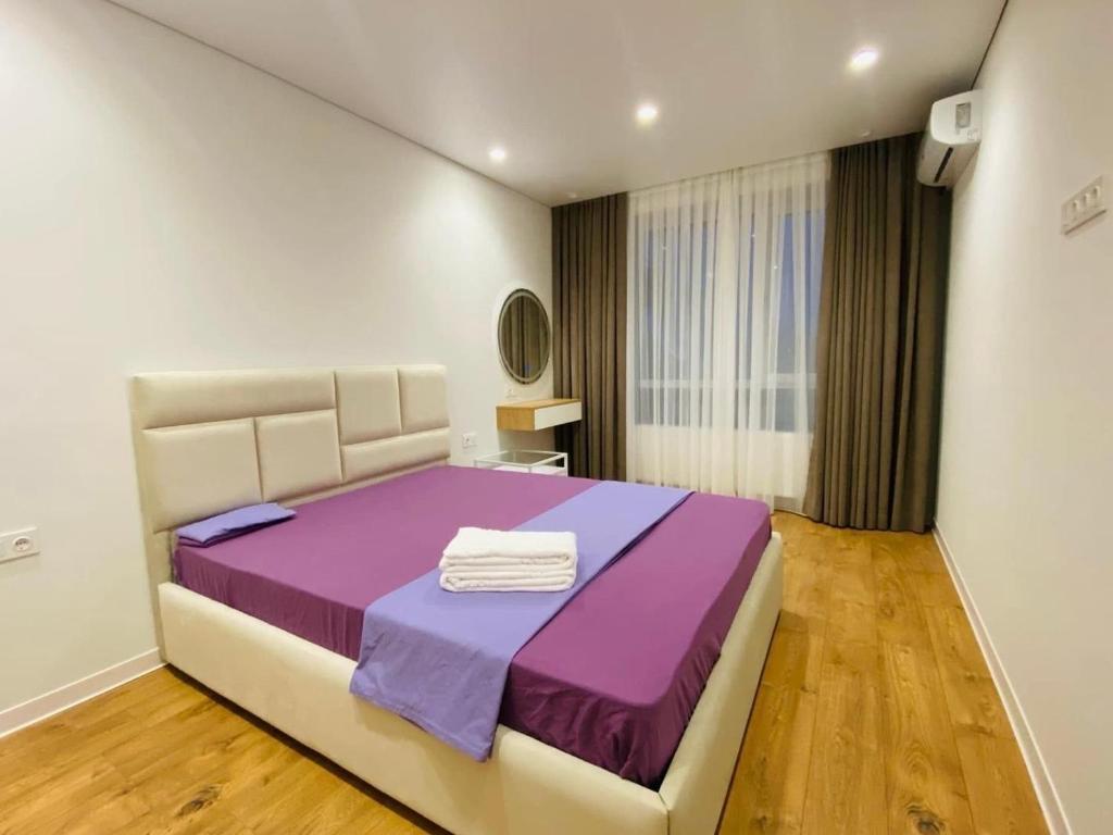 a bedroom with a purple bed in a room at Chișinău Arena in Chişinău