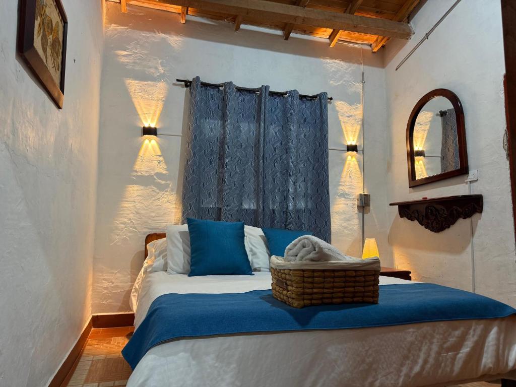a bedroom with a bed with a blue blanket at Casa incluyendo Glamping! 13 personas, Familias con niños in Jardin