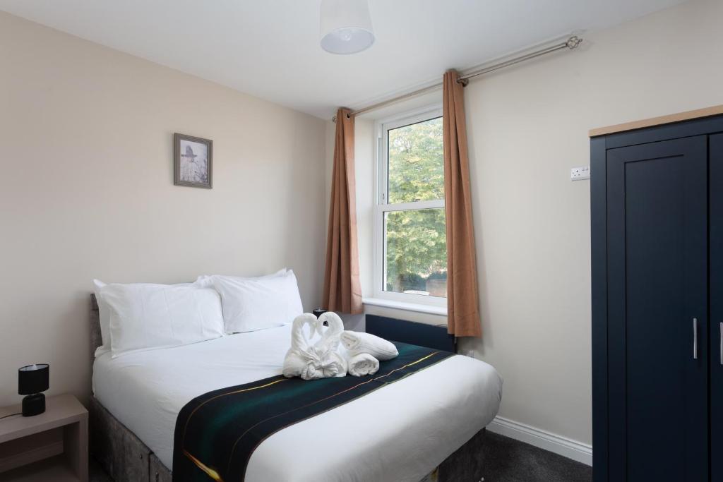 Postel nebo postele na pokoji v ubytování Flat 4 Garth House