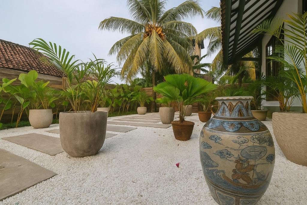 a large vase sitting on the ground with plants at Villa Andia in Gili Air