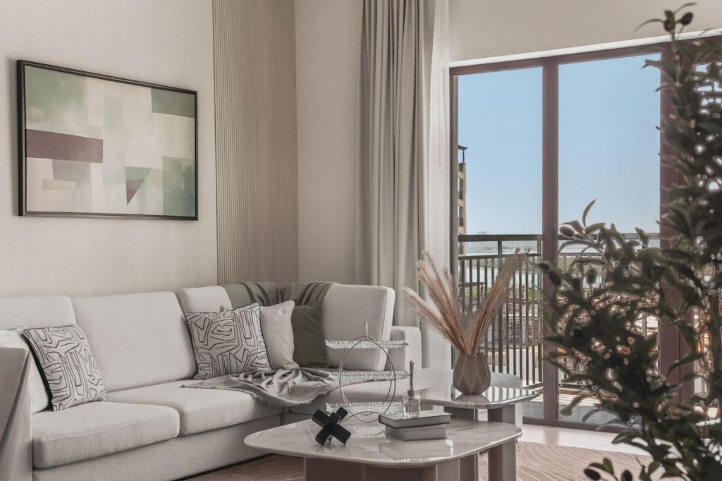 a living room with a couch and a table at F1 Yas Luxury 1BR Golf&Water View w tkt discount in Abu Dhabi