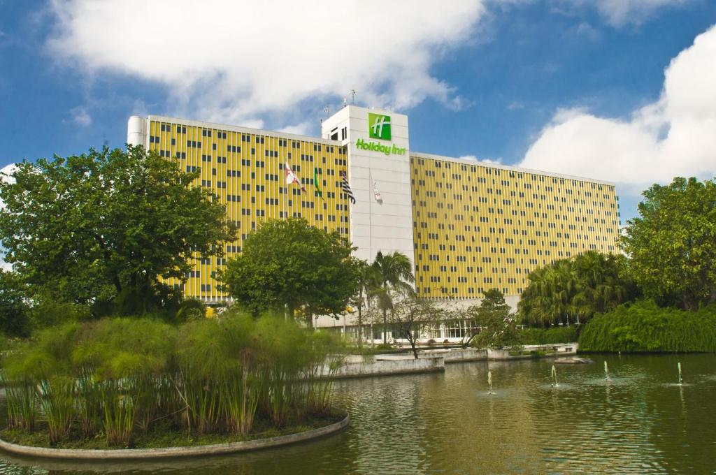 a large building with a pond in front of it at Holiday Inn Sao Paulo Parque Anhembi by IHG in Sao Paulo