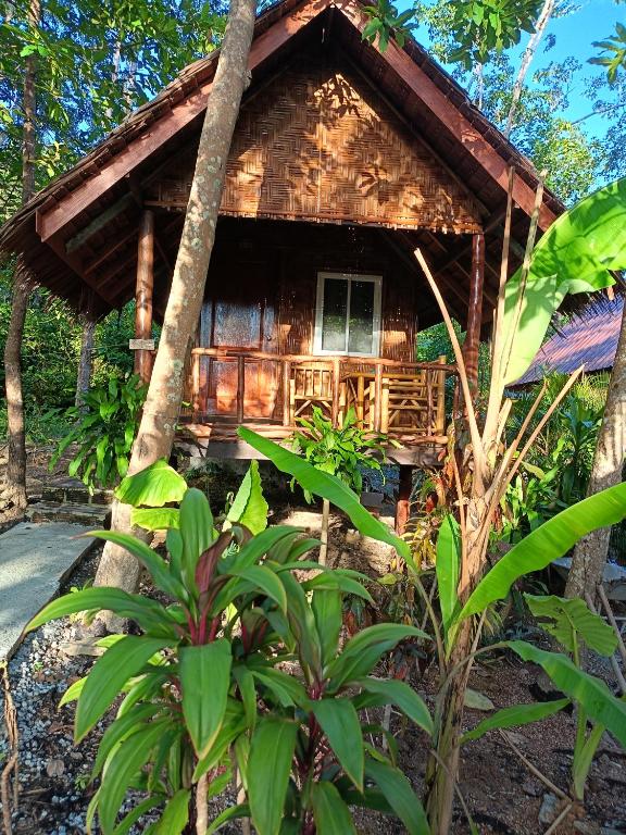 a wooden cabin in the woods with trees at Dahla Lanta Hut in Ko Lanta