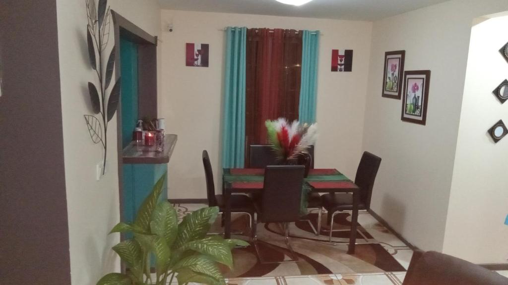 a dining room with a table and chairs at S&D Beauty Home in Roseau