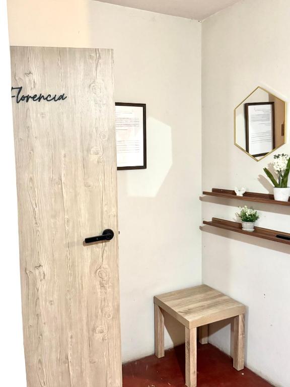 a room with a wooden door and a bench at Florencia Lodgement in Lima