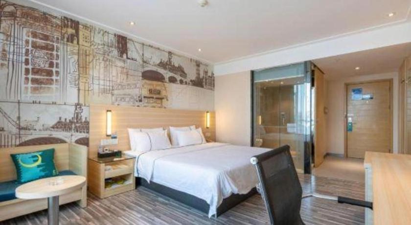 Postel nebo postele na pokoji v ubytování City Comfort Inn Dongguan Shilong Huixing Commercial Center