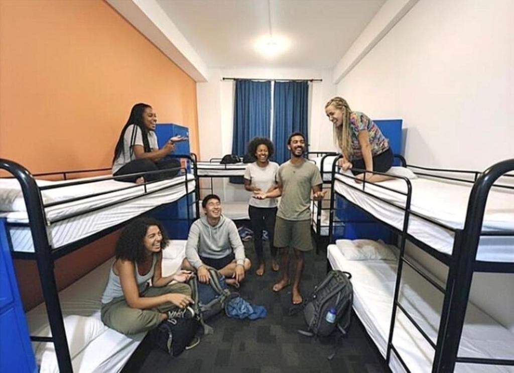 a group of people standing in a room with bunk beds at Big Backpackers Hostel in Sydney