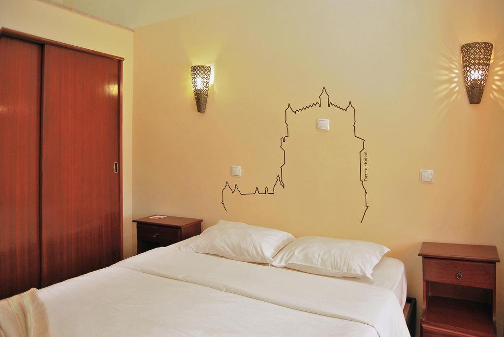 a bedroom with a bed and a lamp at Norte Guest House in Lisbon