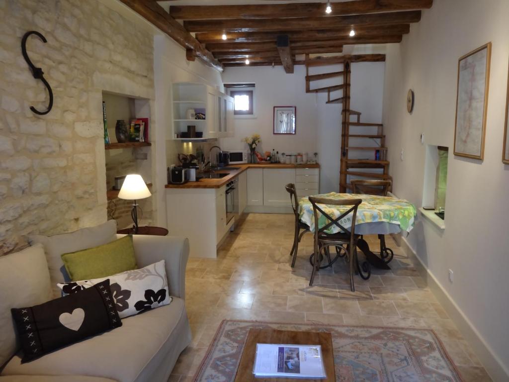 a living room with a couch and a table at The Mews in Puligny-Montrachet