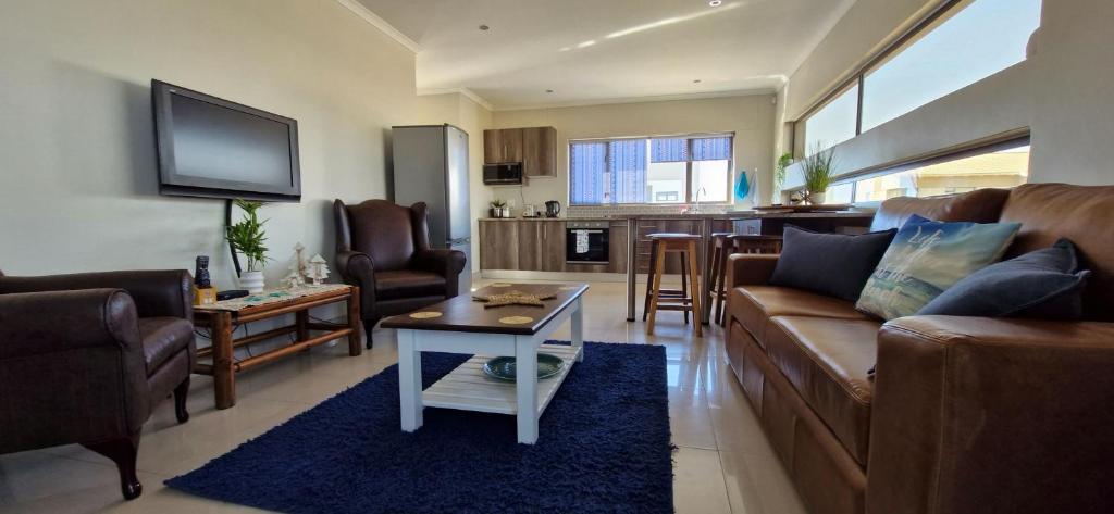 a living room with a couch and a table at Namib's Edge in Swakopmund