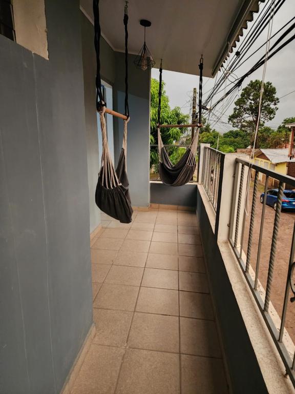 a balcony with two hammocks hanging from the wall at Townhouse in Siguatepeque