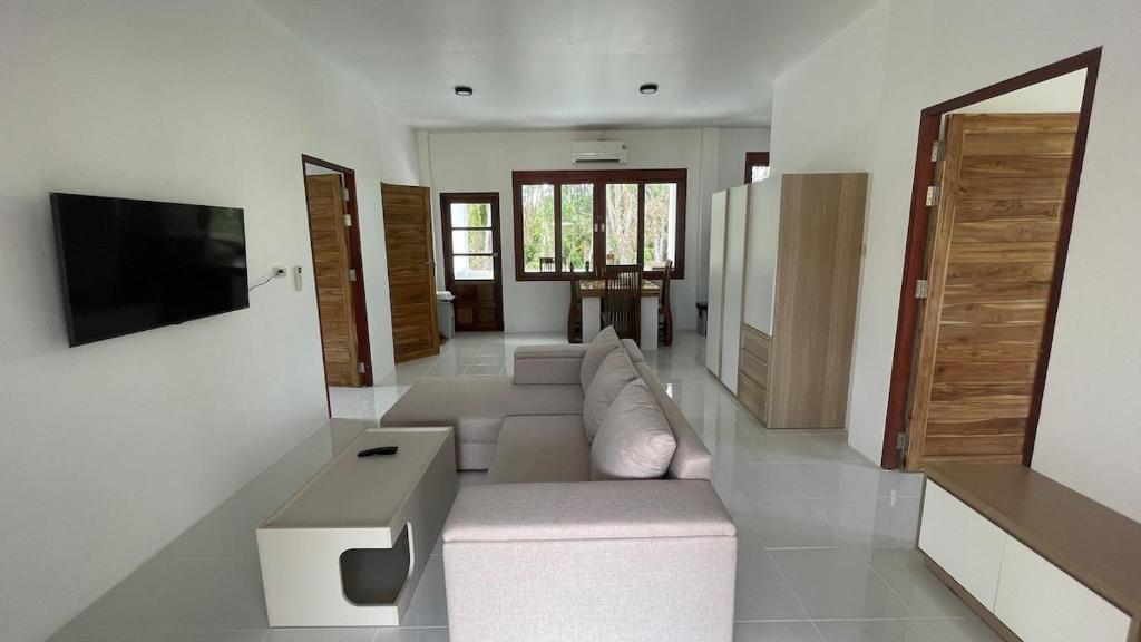 a living room with a couch and a tv at Hin Kong Hide Away 1 in Wok Tum