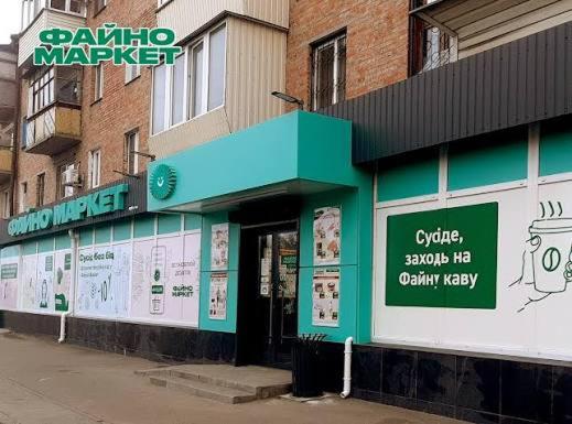 a green and white building on the side of a street at 4х кімнатна квартира in Cherkasy