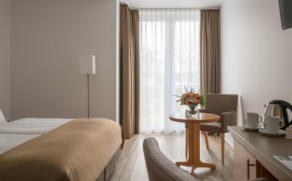 Postel nebo postele na pokoji v ubytování Hotel Chrisma