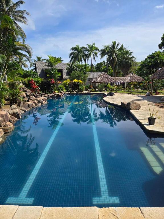 a swimming pool with blue water in a resort at MIRZ Accomodation in Pacific Harbour