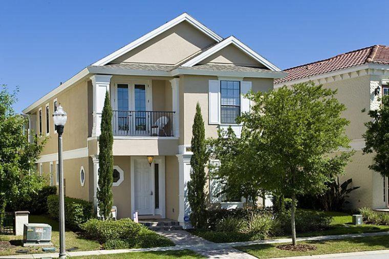 a large house with a balcony on a street at Orlando Family Friendly Home in Kissimmee