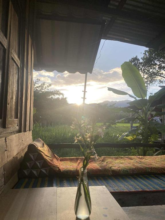 a vase sitting on a table in front of a window at Banana garden in Pai