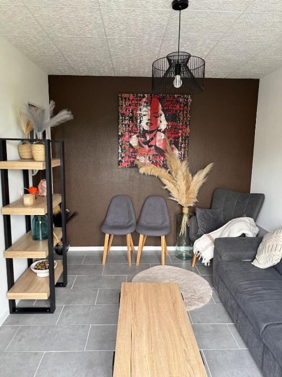 a living room with a couch and two chairs at Pleasant little cottage in Pont-sur-Yonne