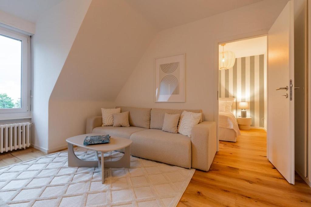 a living room with a couch and a table at Vertical Suite in Zürich