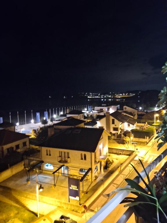 a view of a city at night at Doña Carmen Playa Boutique in Suances