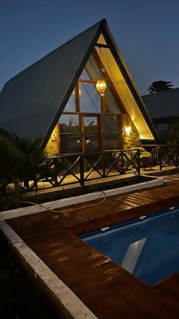 a small house with a pool in front of it at Solo-A-Villa in Paje