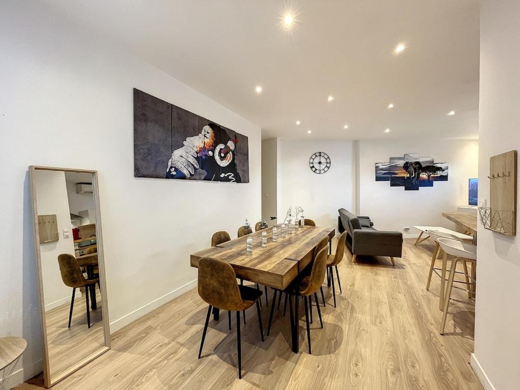 a dining room with a large wooden table and chairs at Cannes luxury apartment in Cannes