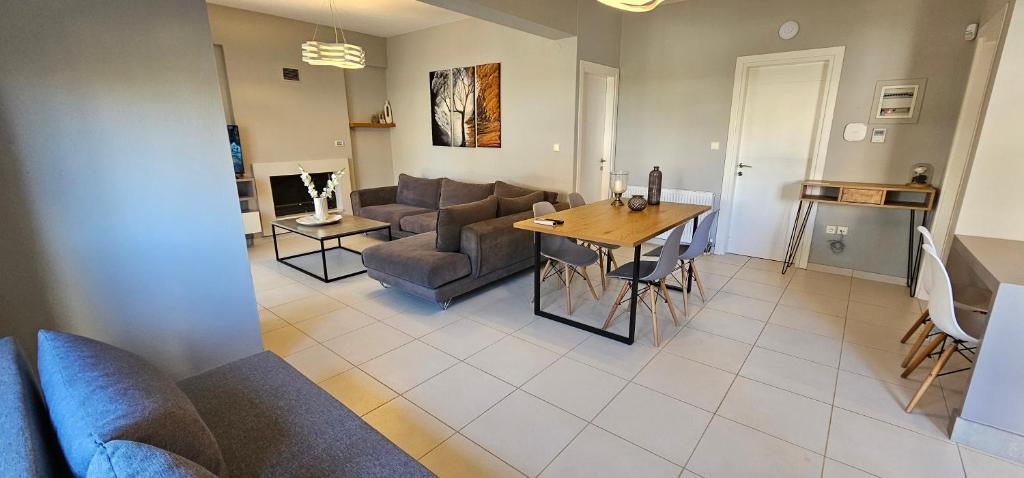 a living room with a couch and a table at ELINOR on the beach in Flogita