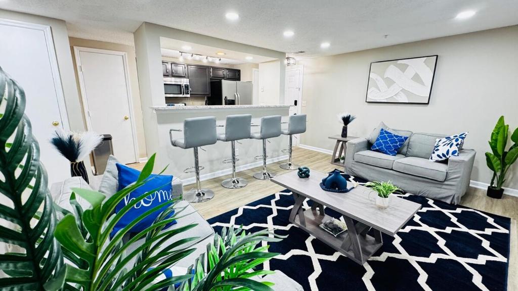 a living room with a couch and a table at Lavish Escape in Charlotte