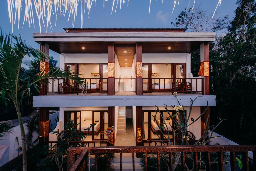 a large house with a balcony in the night at 28 Degrees Lembongan in Nusa Lembongan