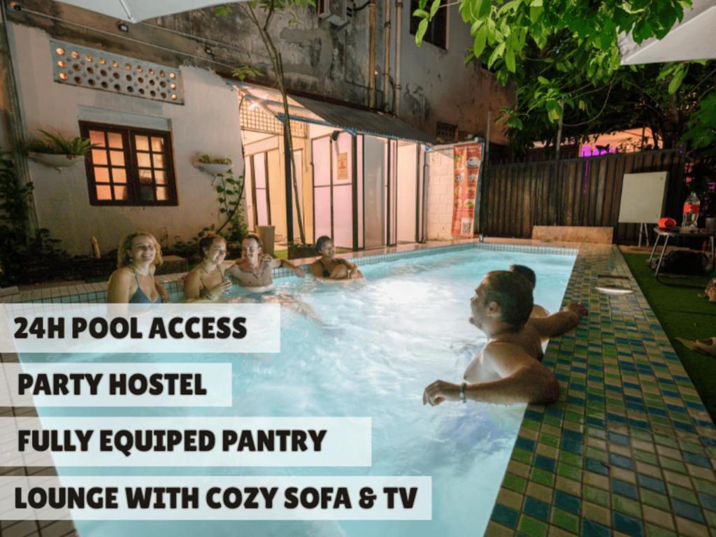 a group of people in a pool at a party hostel at Poolside By Mingle - Party Hostel with Private Pool in Kuala Lumpur
