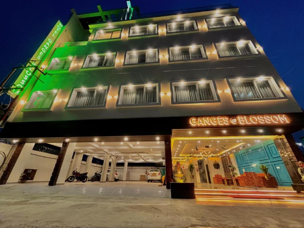 a store front of a building at night at Ganges Blossom Hotel Haridwar in Haridwār