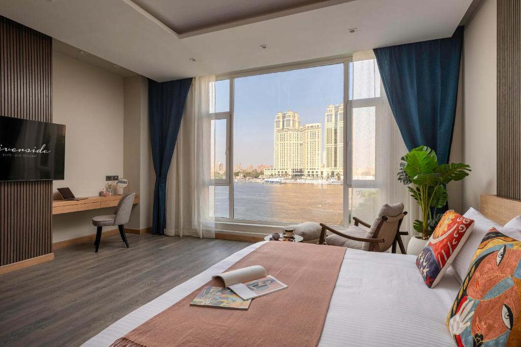 a hotel room with a large bed and a large window at Riverside Hotel in Cairo