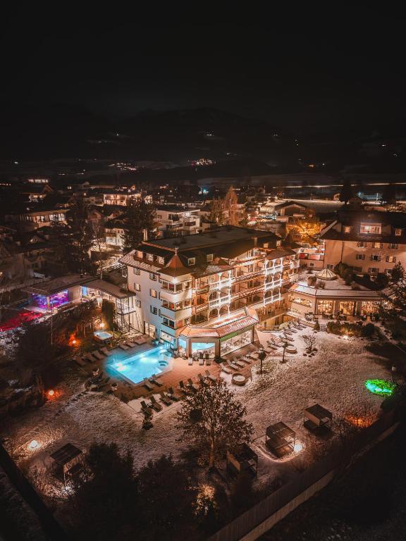 an aerial view of a building at night at Majestic - Unique Spa Resort in Brunico