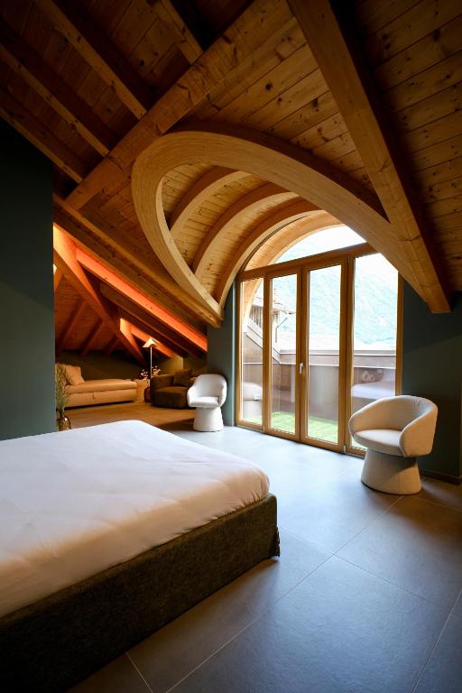 ティラーノにあるSky Room Mountain View - Bernina Experienceの大きなベッドと大きな窓のある寝室