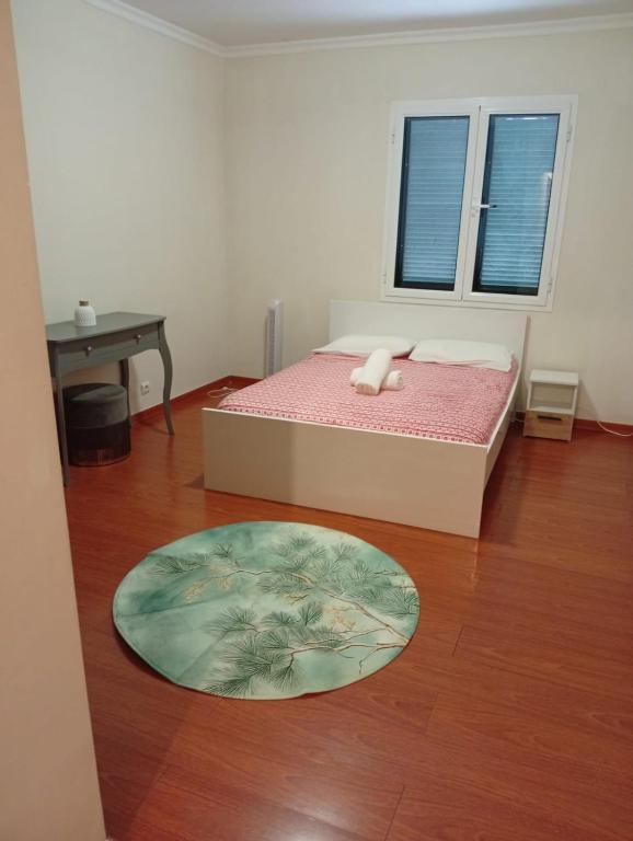 a bedroom with a bed and a table and a window at Geovanny house in Funchal