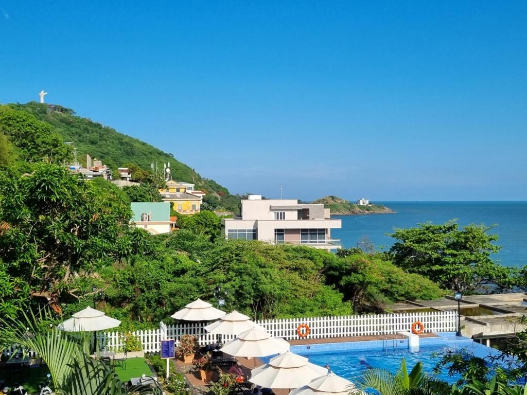 a resort with a swimming pool and the ocean at SV Boutique Resort in Vung Tau