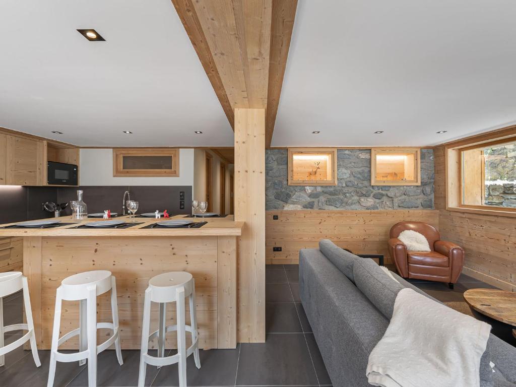 a kitchen and living room with a couch and a table at Appartement familial calme 8 pers, près des pistes - FR-1-565-51 in Les Allues