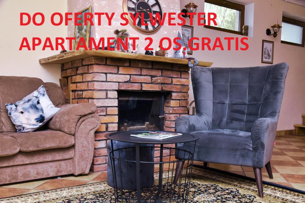 a living room with two chairs and a fireplace at B10 Dom LUX z Alpakami & Basen SPA in Ełk