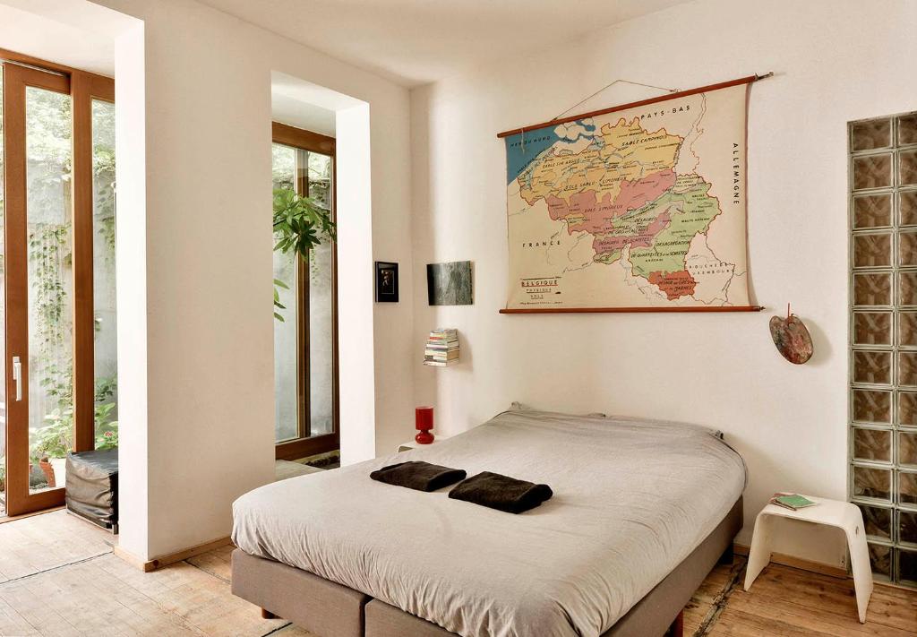 a bedroom with a bed with a map on the wall at B'Kanal in Brussels