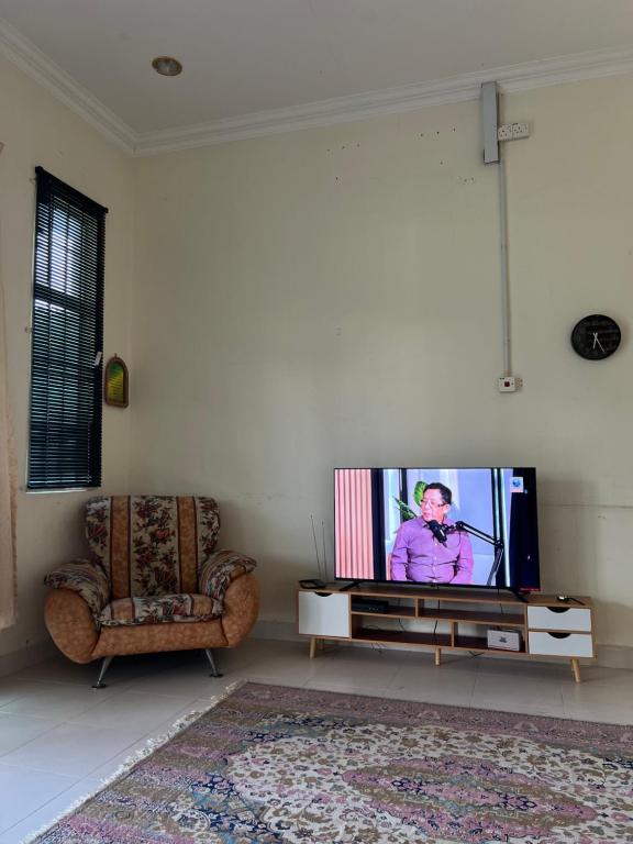 a living room with a flat screen tv on a table at Roomstay Bintong in Kangar