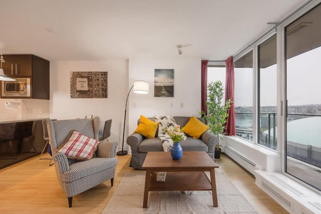 a living room with a couch and chairs and a table at Stylish Vancouver Condo with City Views in Vancouver