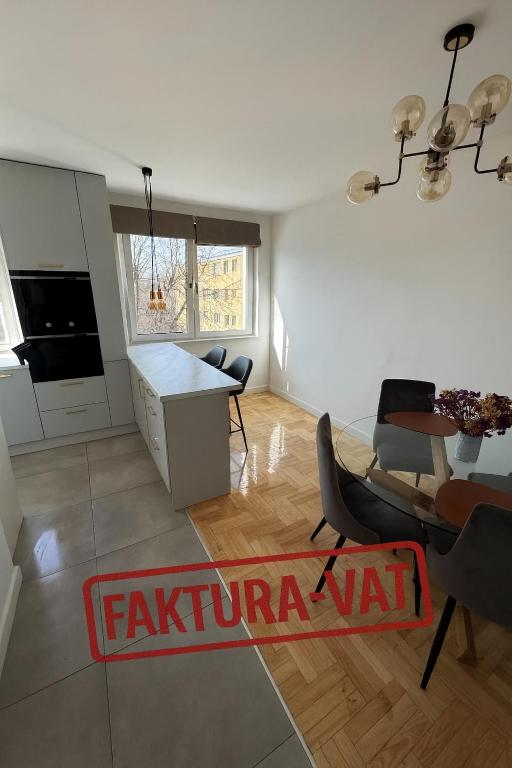 a kitchen and living room with a table and chairs at Marszałkowska City Center Apartment With Working Space in Rzeszów