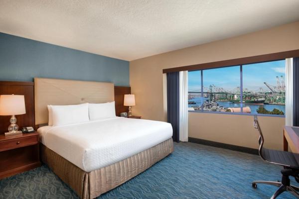 a hotel room with a bed and a large window at Crowne Plaza Hotel Los Angeles Harbor by IHG in San Pedro