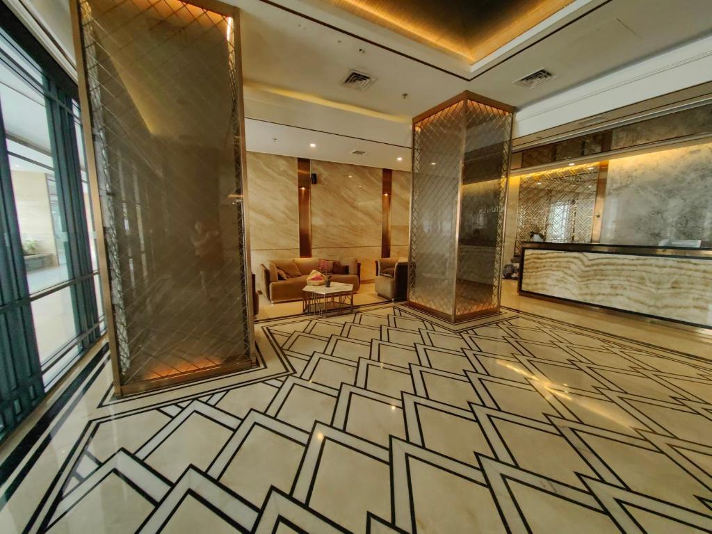 a lobby with a room with a couch and a table at Pollux Meisterstadt Batam Centre Sea View Tower A2 Studio by GoldenSleep in Bagam