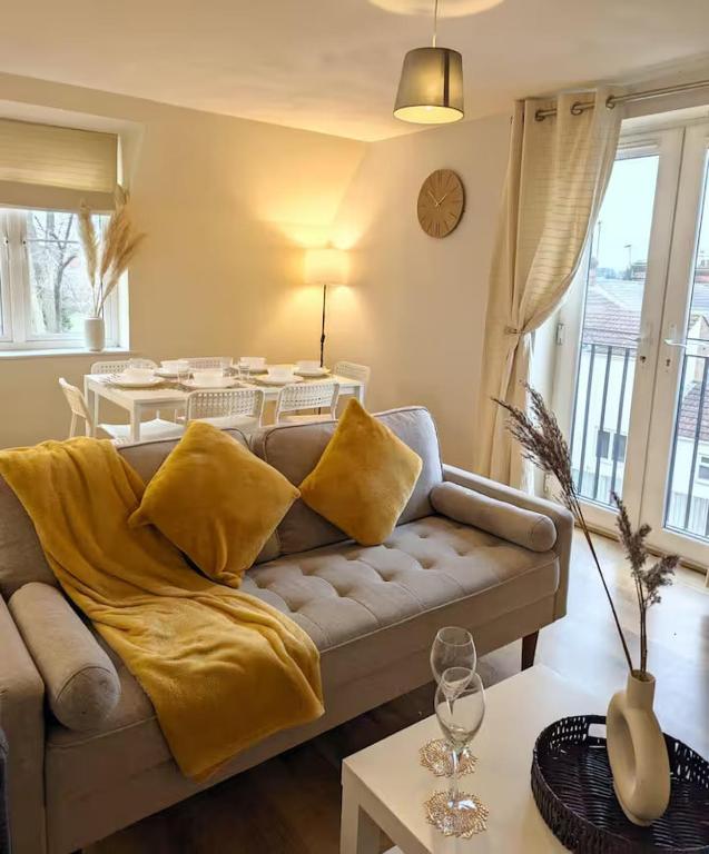 a living room with a couch and a table at Modern 2-Bed in Ipswich - Free Parking & Fast WiFi in Bramford