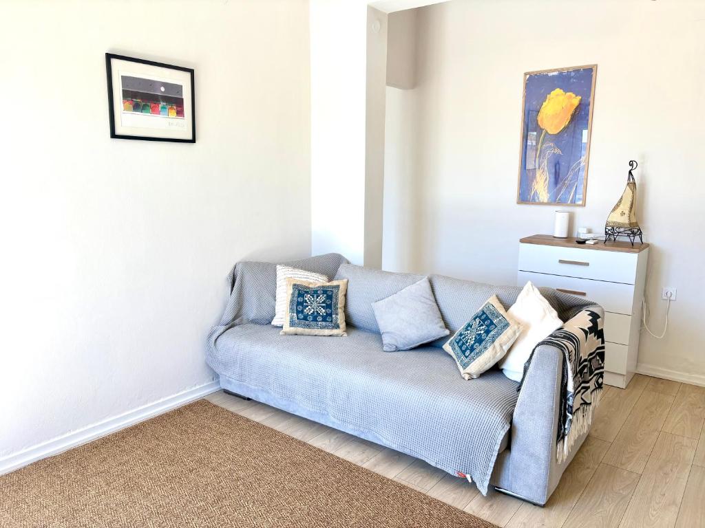 a living room with a couch with pillows on it at Aegina Heights in Aegina Town
