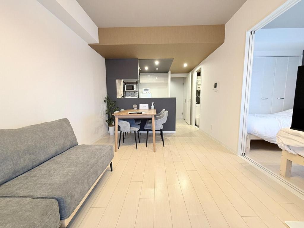 a living room with a couch and a table at Sun Court Nango-dori サンコート南郷通 1003 in Sapporo