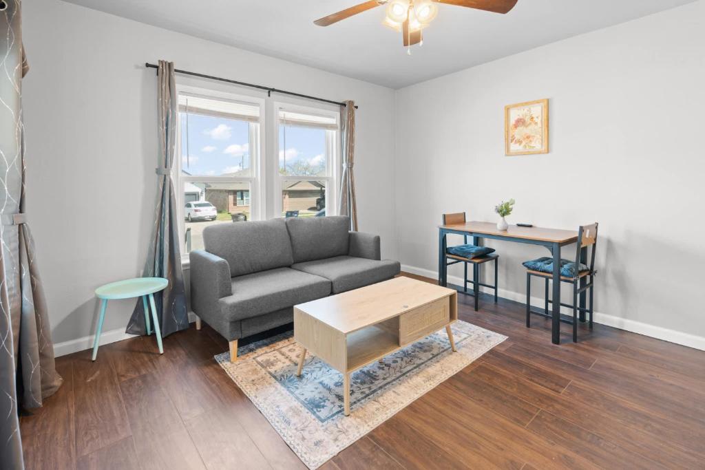 a living room with a couch and a table at Charming 1-Bedroom Retreat in Fort Worth in Fort Worth