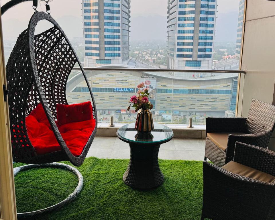 a swing in a room with a view of a city at Skyline Hotel Apartments-Elysium Tower Facing Centaurus Mall Islamabad in Islamabad