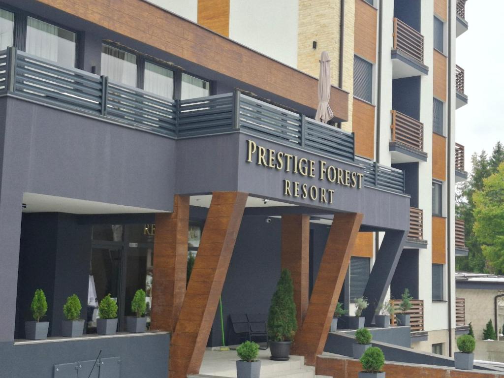a building with a sign that reads prestige forest resort at Apartman Zlatibor in Zlatibor